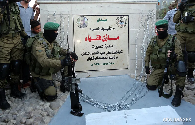 Members of the Ezzedine al-Qassam Brigades, the military wing of the Palestinian Islamist movement Hamas take part during the opening ceremony of Mazen Faqha square, in Nusseir at refugee camp, in the central Gaza Strip,...