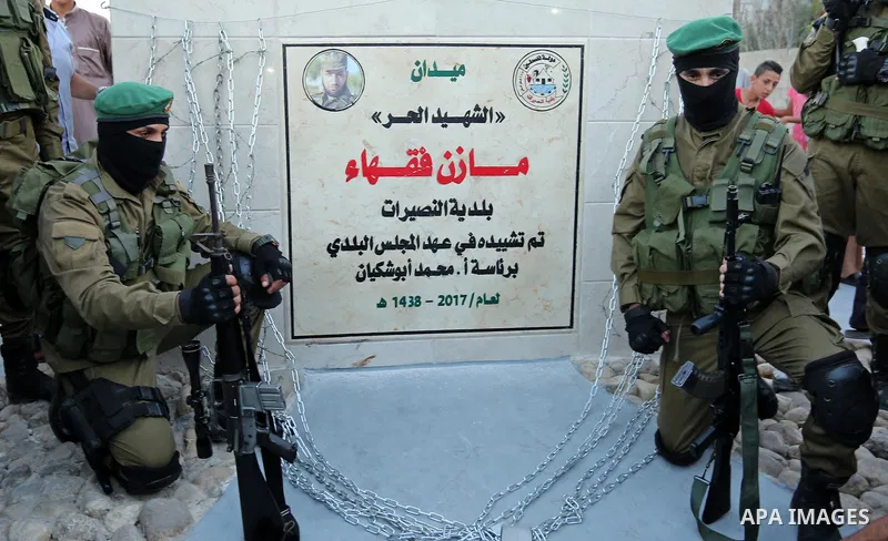 Members of the Ezzedine al-Qassam Brigades, the military wing of the Palestinian Islamist movement Hamas take part during the opening ceremony of Mazen Faqha square, in Nusseir at refugee camp, in the central Gaza Strip,...