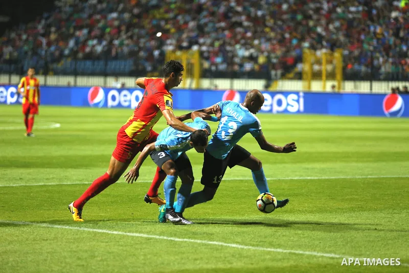 Jordan's Al-Faisaly players and Tunis Esperance players compete during the Arab Club championship final match in Alexandria Stadium on August 6, 2017. Photo by Stringer
