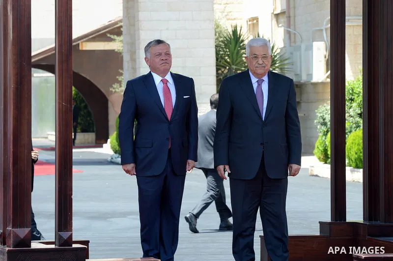 Jordan's King Abdullah II and Palestinian president Mahmud Abbas observes the honor guard during a visit in the West Bank city of Ramallah on August 7, 2017. Jordan's King began a rare visit to the occupied West Bank to...