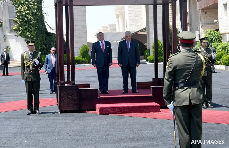 Jordan's King Abdullah II and Palestinian president Mahmud Abbas observes the honor guard during a visit in the West Bank city of Ramallah on August 7, 2017. Jordan's King began a rare visit to the occupied West Bank to...