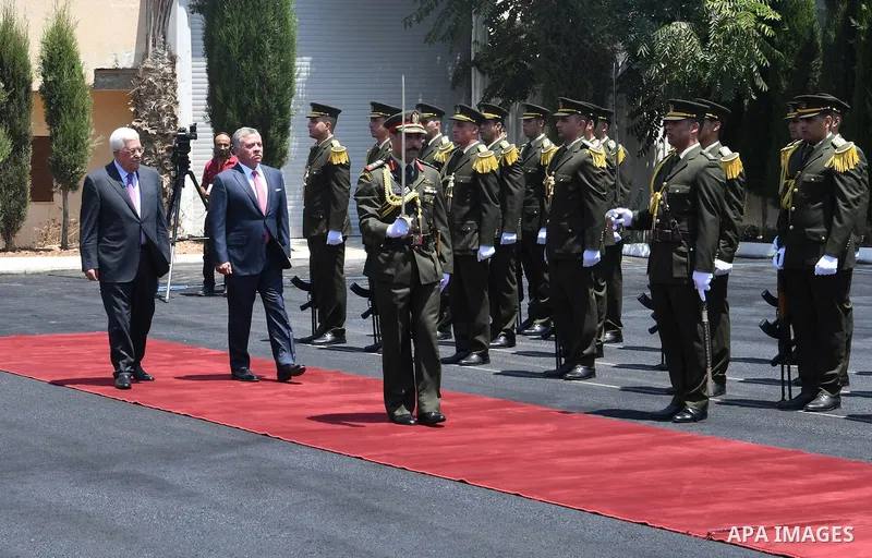 Jordan's King Abdullah II and Palestinian president Mahmud Abbas observes the honor guard during a visit in the West Bank city of Ramallah on August 7, 2017. Jordan's King began a rare visit to the occupied West Bank to...