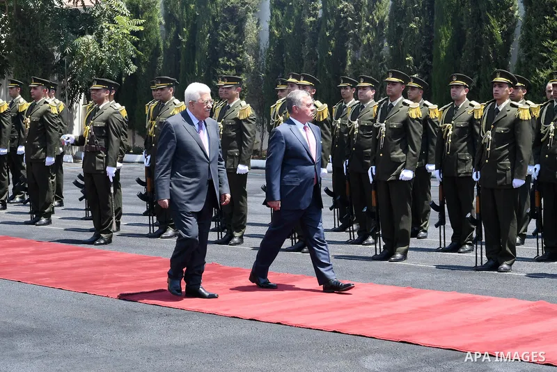Jordan's King Abdullah II and Palestinian president Mahmud Abbas observes the honor guard during a visit in the West Bank city of Ramallah on August 7, 2017. Jordan's King began a rare visit to the occupied West Bank to...