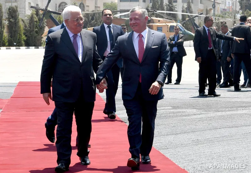 Jordan's King Abdullah II and Palestinian president Mahmud Abbas observes the honor guard during a visit in the West Bank city of Ramallah on August 7, 2017. Jordan's King began a rare visit to the occupied West Bank to...