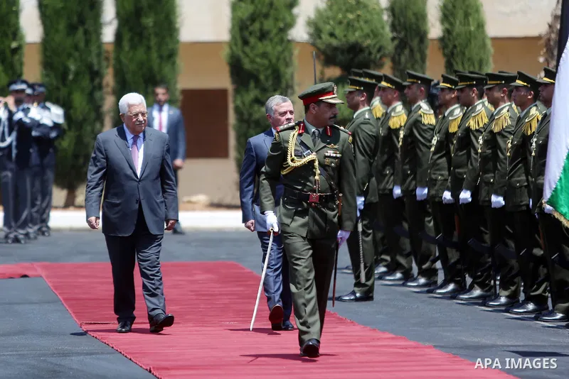 Jordan's King Abdullah II and Palestinian president Mahmud Abbas observes the honor guard during a visit in the West Bank city of Ramallah on August 7, 2017. Jordan's King began a rare visit to the occupied West Bank to...