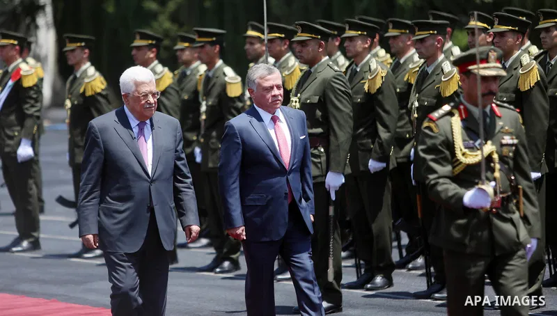 Jordan's King Abdullah II and Palestinian president Mahmud Abbas observes the honor guard during a visit in the West Bank city of Ramallah on August 7, 2017. Jordan's King began a rare visit to the occupied West Bank to...