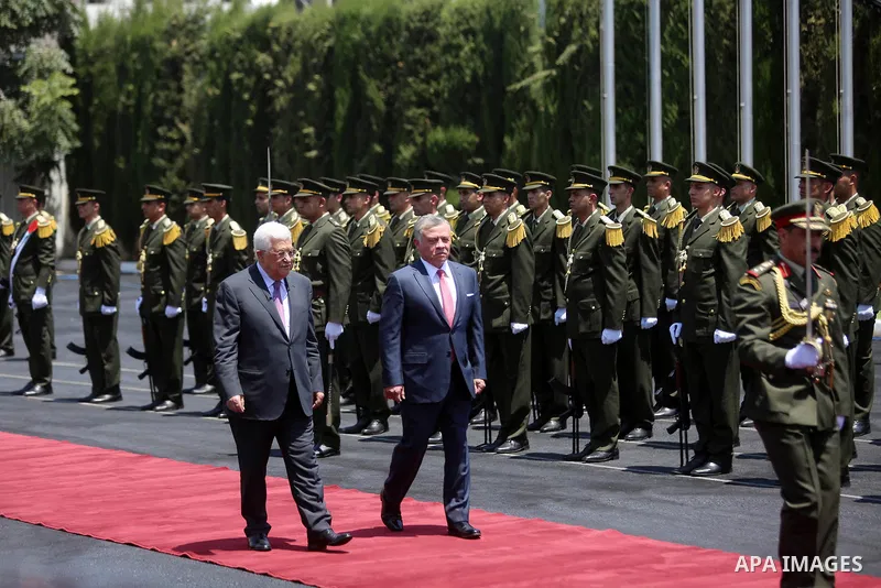 Jordan's King Abdullah II and Palestinian president Mahmud Abbas observes the honor guard during a visit in the West Bank city of Ramallah on August 7, 2017. Jordan's King began a rare visit to the occupied West Bank to...