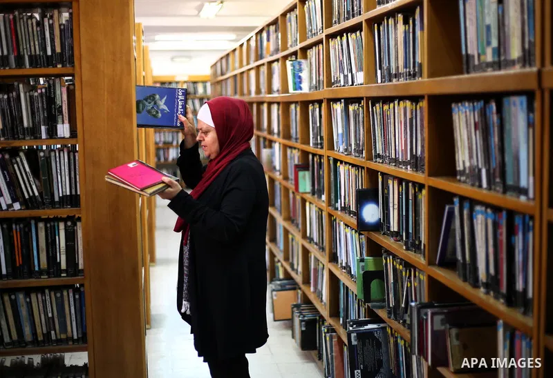 A Palestinian researcher selects a book at Nablus public library in the West Bank city of Nablus, on August 6, 2017. Nablus public library, the largest, and the oldest, in all of Palestine, opened in 1960, and library in...