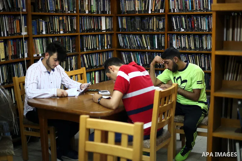 Palestinian students read books at Nablus public library in the West Bank city of Nablus, on August 6, 2017. Nablus public library, the largest, and the oldest, in all of Palestine, opened in 1960, and library includes a...