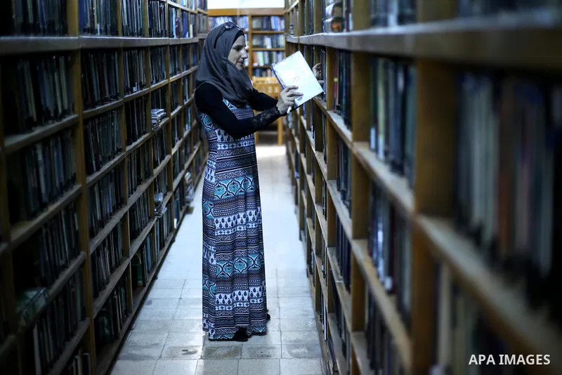 A Palestinian researcher selects a book at Nablus public library in the West Bank city of Nablus, on August 6, 2017. Nablus public library, the largest, and the oldest, in all of Palestine, opened in 1960, and library in...