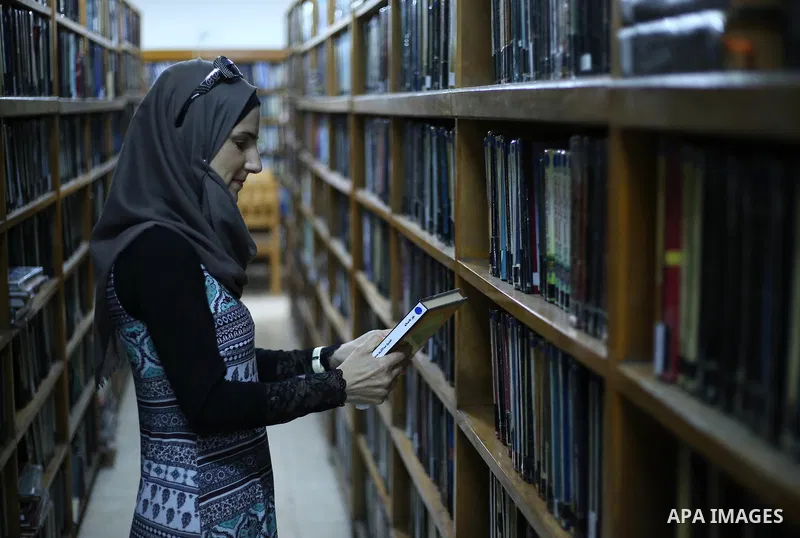 A Palestinian researcher selects a book at Nablus public library in the West Bank city of Nablus, on August 6, 2017. Nablus public library, the largest, and the oldest, in all of Palestine, opened in 1960, and library in...
