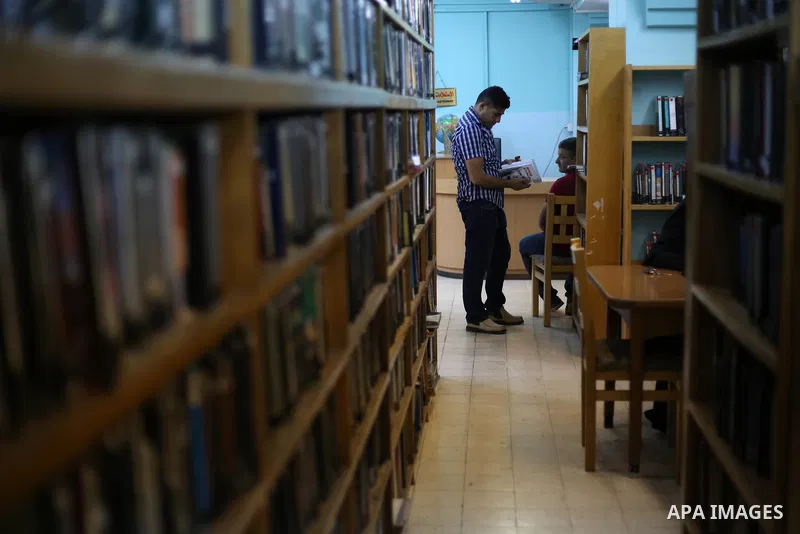 Palestinian students read books at Nablus public library in the West Bank city of Nablus, on August 6, 2017. Nablus public library, the largest, and the oldest, in all of Palestine, opened in 1960, and library includes a...