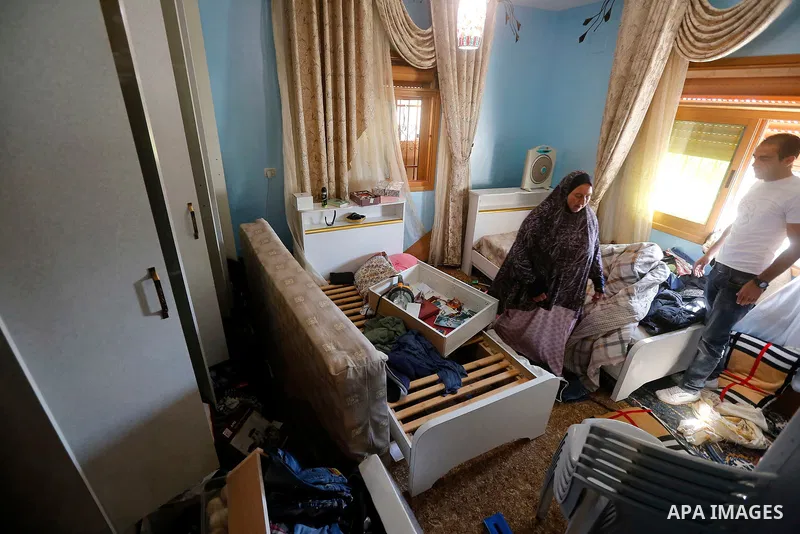 Palestinians check a damage after the Israeli army stormed the house and arrested two people, in the West Bank city of Hebron, on August 8, 2017. Israeli army stormed two house in the last night in hebron search for weap...