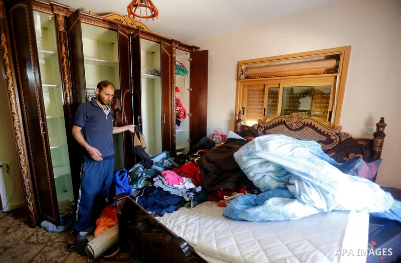 Palestinians check a damage after the Israeli army stormed the house and arrested two people, in the West Bank city of Hebron, on August 8, 2017. Israeli army stormed two house in the last night in hebron search for weap...