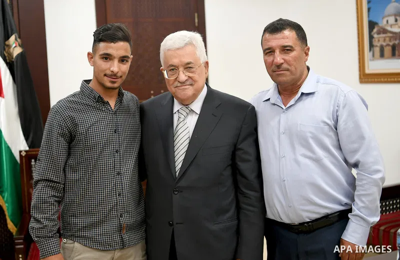 Palestinian President Mahmoud Abbas meets with Firas Bassam Abu Awwad, 17, who was lost his family in a traffic accident with an Israeli military vehicle in 2010, at his headquarter in the West Bank city of Ramallah on A...