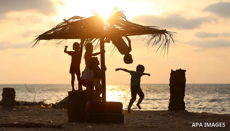 Palestinian children enjoy their time at the beach of the Mediterranean sea on the coast of Gaza city on August 9, 2017. Photo by Yasser Qudih