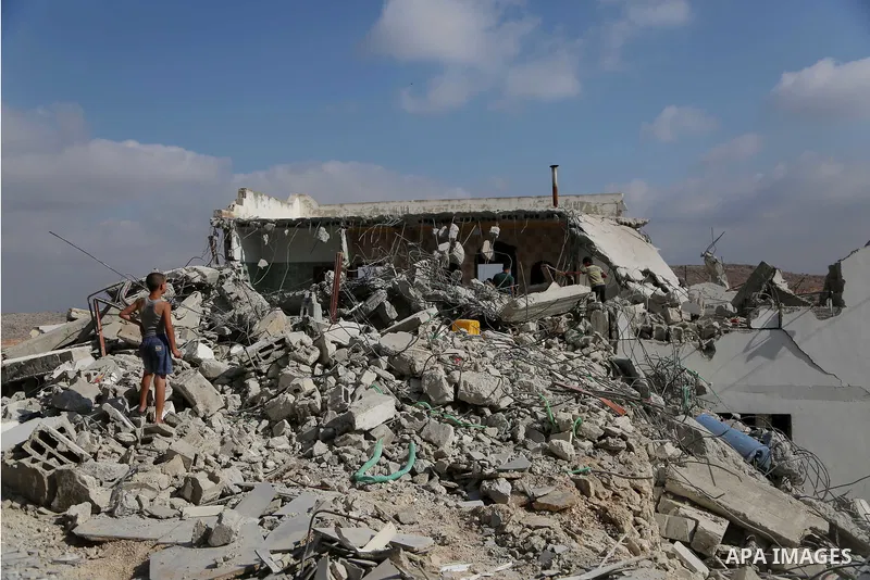 People walk through the rubble of the house of a Palestinian assailant after it was demolished by Israeli troops in the West Bank village of Deir Abu Mashal, near Ramallah August 10, 2017. Photo by Shadi Hatem