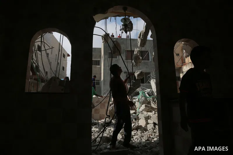 People gather around the remains of the house of a Palestinian assailant after it was demolished by Israeli troops in the West Bank village of Deir Abu Mashal, near Ramallah August 10, 2017. Photo by Shadi Hatem