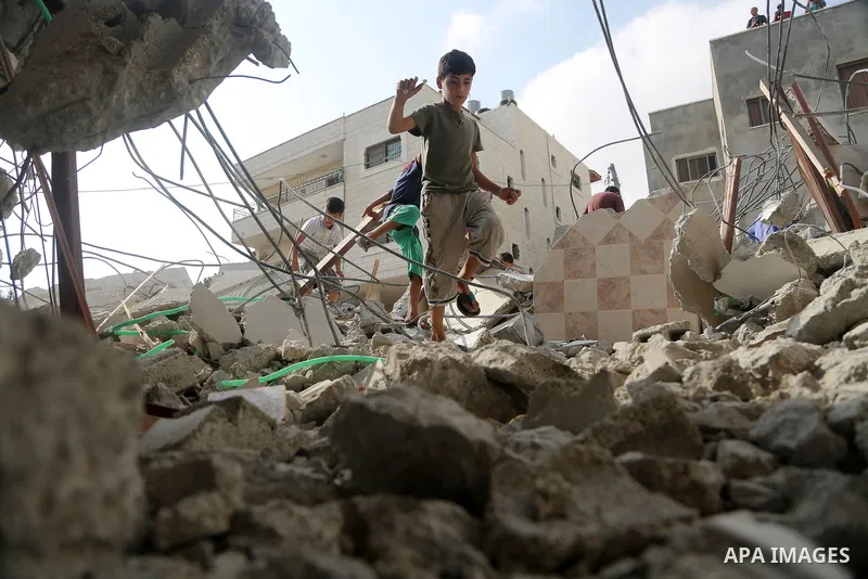 People gather around the remains of the house of a Palestinian assailant after it was demolished by Israeli troops in the West Bank village of Deir Abu Mashal, near Ramallah August 10, 2017. Photo by Shadi Hatem