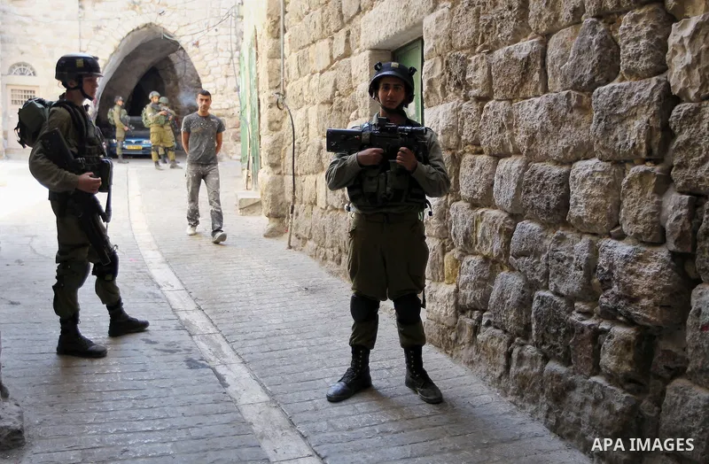 Israeli troops patrol a street in the West Bank city of Hebron, on August 10, 2017. Israeli authorities have demolished three homes and sealed off a fourth of Palestinians who carried out attacks that killed a soldier an...