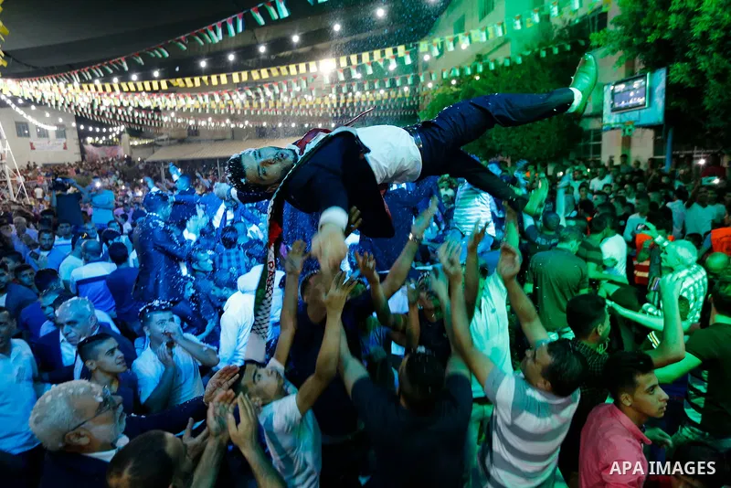 Palestinians dance during a mass wedding funded by Palestinian President Mahmoud Abbas in the West Bank village of Tafouh, east of Hebron, on August 10, 2017. Photo by Wisam Hashlamoun