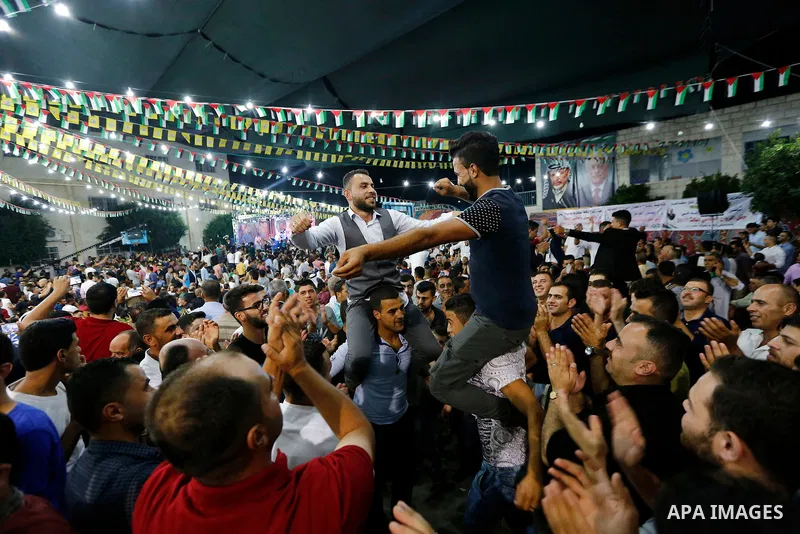Palestinians dance during a mass wedding funded by Palestinian President Mahmoud Abbas in the West Bank village of Tafouh, east of Hebron, on August 10, 2017. Photo by Wisam Hashlamoun