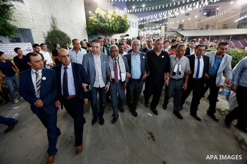 Palestinians take part in a mass wedding funded by Palestinian President Mahmoud Abbas in the West Bank village of Tafouh, east of Hebron, on August 10, 2017. Photo by Wisam Hashlamoun