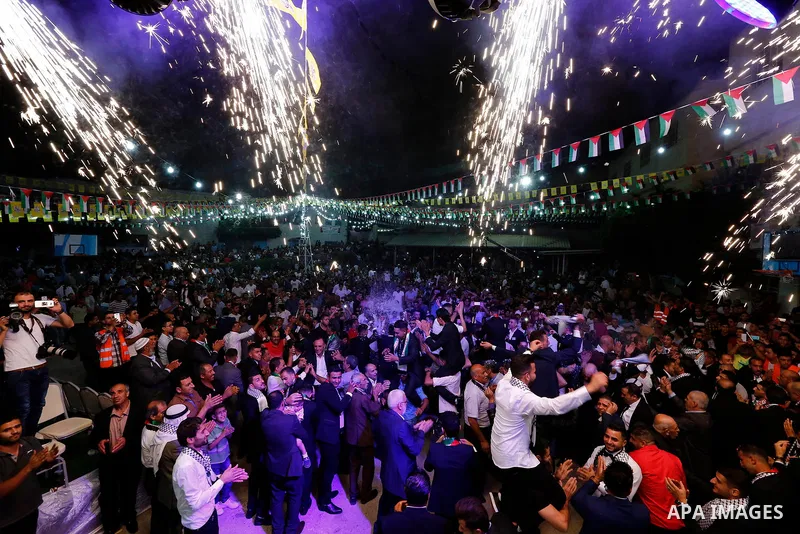 Palestinians dance during a mass wedding funded by Palestinian President Mahmoud Abbas in the West Bank village of Tafouh, east of Hebron, on August 10, 2017. Photo by Wisam Hashlamoun