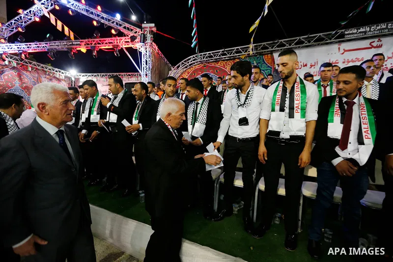 Thirty nine Palestinian grooms take part in a mass wedding funded by Palestinian President Mahmoud Abbas in the West Bank village of Tafouh, east of Hebron, on August 10, 2017. Photo by Wisam Hashlamoun