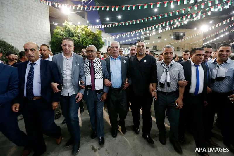 Palestinians take part in a mass wedding funded by Palestinian President Mahmoud Abbas in the West Bank village of Tafouh, east of Hebron, on August 10, 2017. Photo by Wisam Hashlamoun