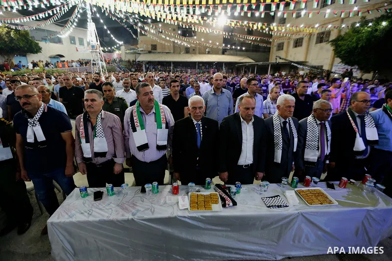 Palestinians take part in a mass wedding funded by Palestinian President Mahmoud Abbas in the West Bank village of Tafouh, east of Hebron, on August 10, 2017. Photo by Wisam Hashlamoun