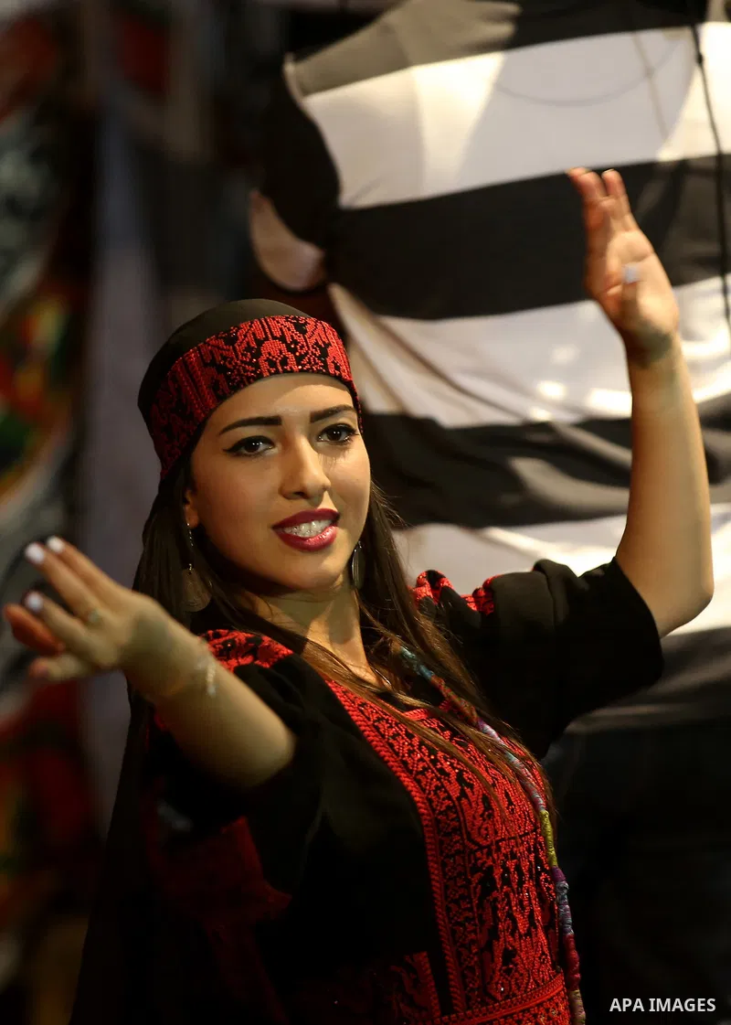 Members of Palestinian dance Dabka band perform during a mass wedding ceremony for 65 couples funded by Palestinian President Mahmoud Abbas at Al-Fara refugee camp near the West Bank city of Nablus, on August 10, 2017. P...