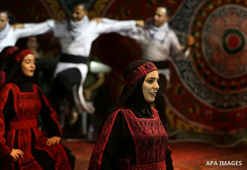 Members of Palestinian dance Dabka band perform during a mass wedding ceremony for 65 couples funded by Palestinian President Mahmoud Abbas at Al-Fara refugee camp near the West Bank city of Nablus, on August 10, 2017. P...