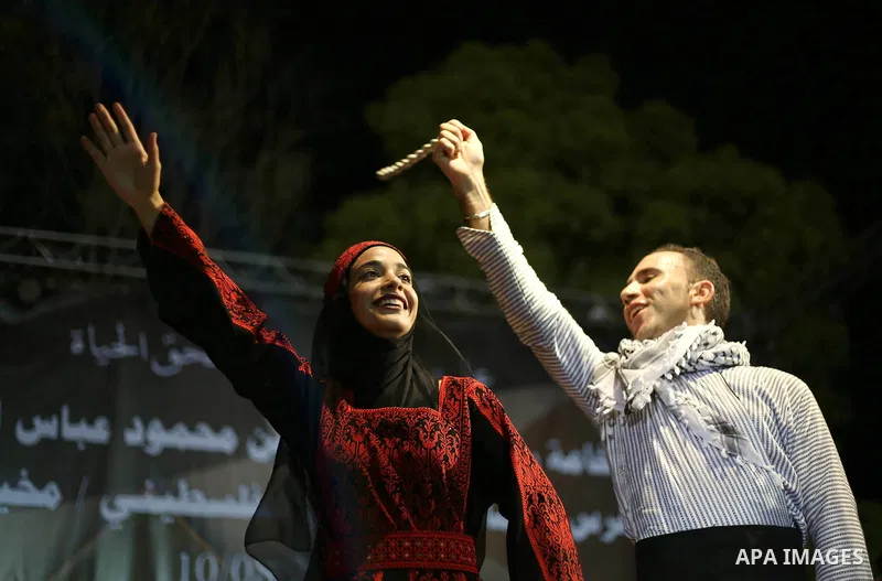 Members of Palestinian dance Dabka band perform during a mass wedding ceremony for 65 couples funded by Palestinian President Mahmoud Abbas at Al-Fara refugee camp near the West Bank city of Nablus, on August 10, 2017. P...