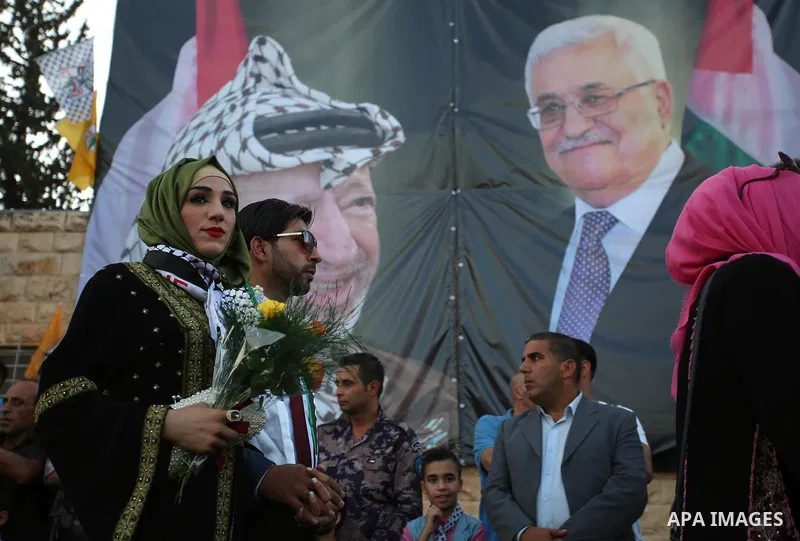 Palestinian 65 couples take part in a mass wedding ceremony funded by Palestinian President Mahmoud Abbas at Al-Fara refugee camp near the West Bank city of Nablus, on August 10, 2017. Photo by Ayman Ameen