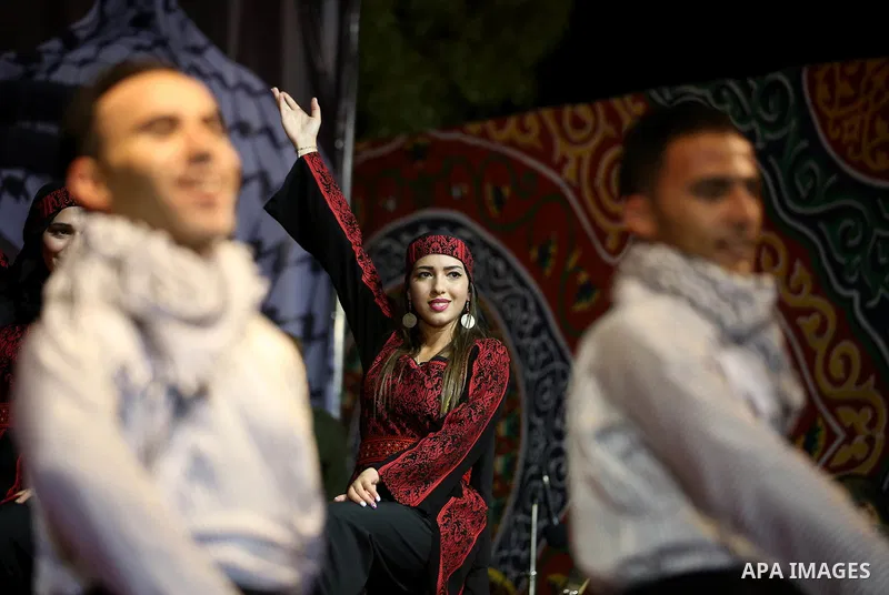Members of Palestinian dance Dabka band perform during a mass wedding ceremony for 65 couples funded by Palestinian President Mahmoud Abbas at Al-Fara refugee camp near the West Bank city of Nablus, on August 10, 2017. P...