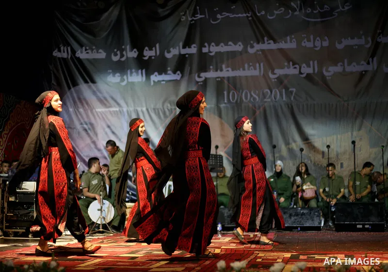 Members of Palestinian dance Dabka band perform during a mass wedding ceremony for 65 couples funded by Palestinian President Mahmoud Abbas at Al-Fara refugee camp near the West Bank city of Nablus, on August 10, 2017. P...