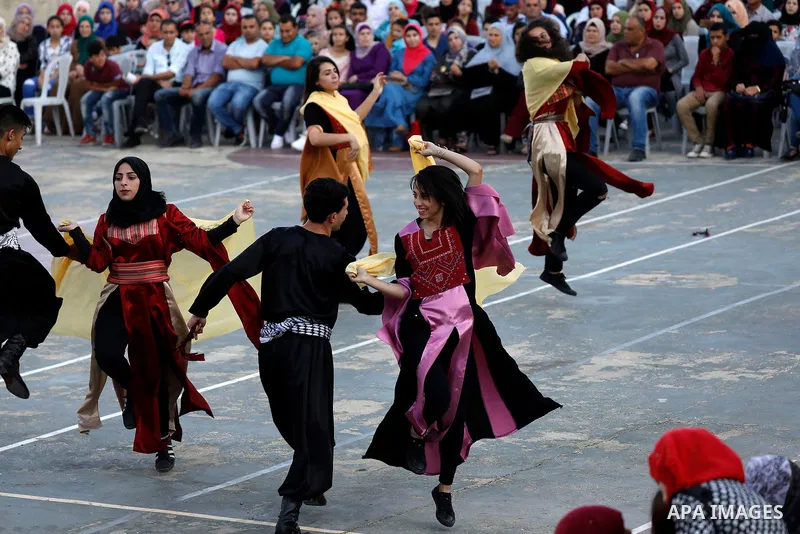 Palestinian youth perform traditional Palestinian dance during the Festival of the movement of Palestinian National Initiative Mustafa Barghouti in West Bank city of Bethlehem on August 12, 2017. Photo by Wisam Hashlamou...