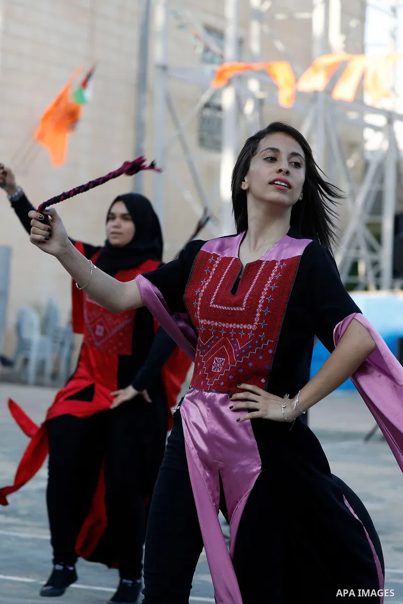 Palestinian youth perform traditional Palestinian dance during the Festival of the movement of Palestinian National Initiative Mustafa Barghouti in West Bank city of Bethlehem on August 12, 2017. Photo by Wisam Hashlamou...