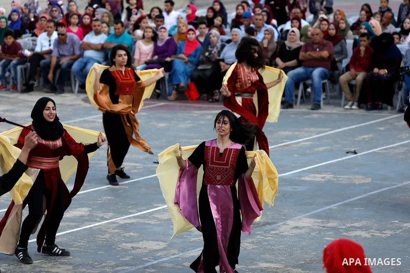 Palestinian youth perform traditional Palestinian dance during the Festival of the movement of Palestinian National Initiative Mustafa Barghouti in West Bank city of Bethlehem on August 12, 2017. Photo by Wisam Hashlamou...