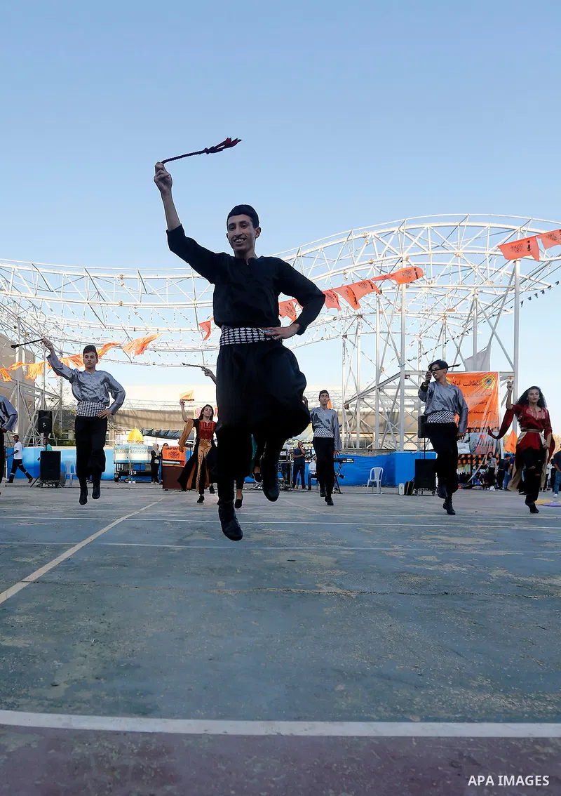 Palestinian youth perform traditional Palestinian dance during the Festival of the movement of Palestinian National Initiative Mustafa Barghouti in West Bank city of Bethlehem on August 12, 2017. Photo by Wisam Hashlamou...