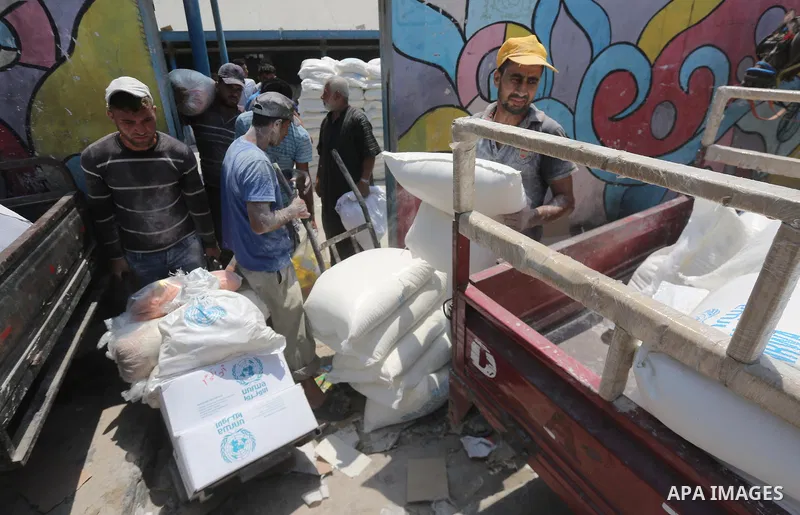 Palestinians receive their monthly food aid at a United Nations distribution center (UNRWA) in Gaza city on August 13, 2017. Photo by Mohammed Asad