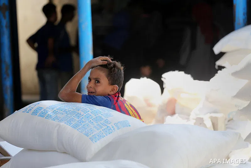 Palestinians receive their monthly food aid at a United Nations distribution center (UNRWA) in Gaza city on August 13, 2017. Photo by Mohammed Asad