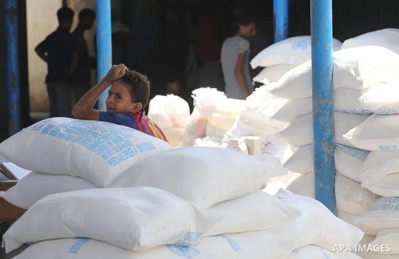 Palestinians receive their monthly food aid at a United Nations distribution center (UNRWA) in Gaza city on August 13, 2017. Photo by Mohammed Asad