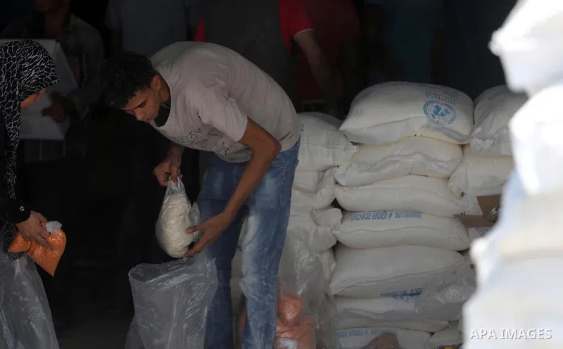 Palestinians receive their monthly food aid at a United Nations distribution center (UNRWA) in Gaza city on August 13, 2017. Photo by Mohammed Asad