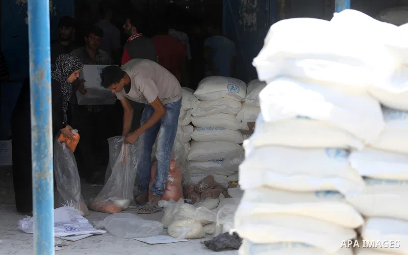 Palestinians receive their monthly food aid at a United Nations distribution center (UNRWA) in Gaza city on August 13, 2017. Photo by Mohammed Asad