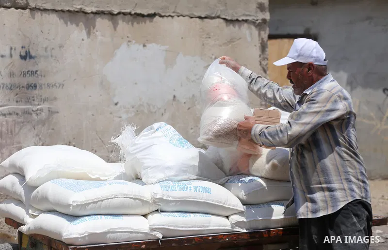Palestinians receive their monthly food aid at a United Nations distribution center (UNRWA) in Gaza city on August 13, 2017. Photo by Mohammed Asad