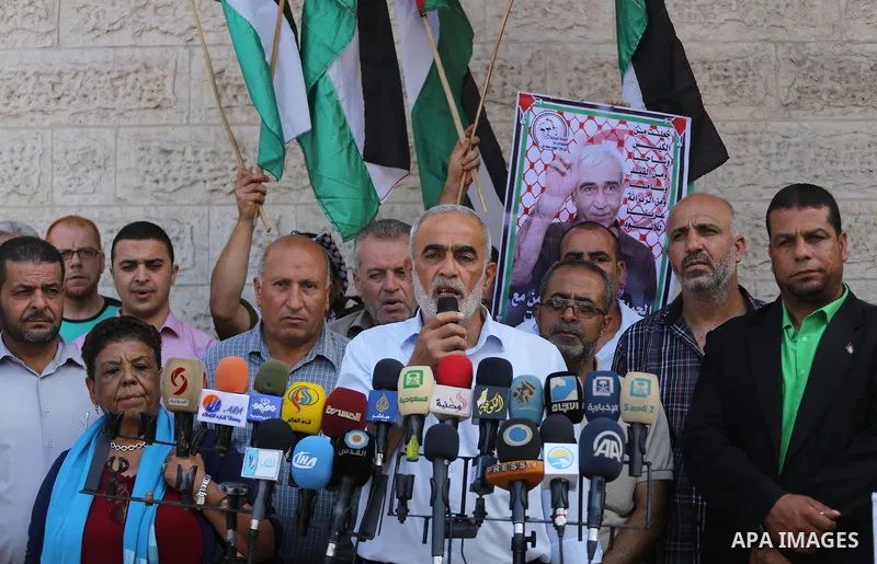 Palestinian members of the factions attend in a press conference, in front of Red Cross Office, in Gaza city, on August 14, 2017. Photo by Mohammed Asad