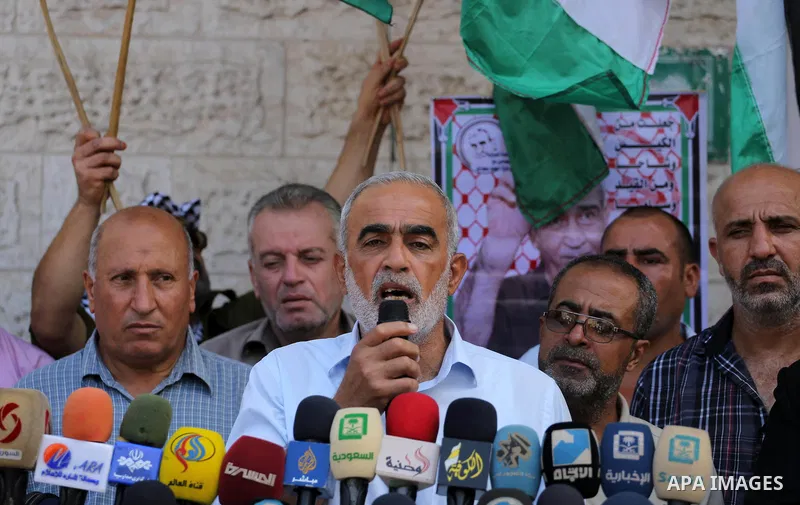 Palestinian members of the factions attend in a press conference, in front of Red Cross Office, in Gaza city, on August 14, 2017. Photo by Mohammed Asad