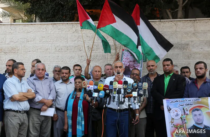 Palestinian members of the factions attend in a press conference, in front of Red Cross Office, in Gaza city, on August 14, 2017. Photo by Mohammed Asad
